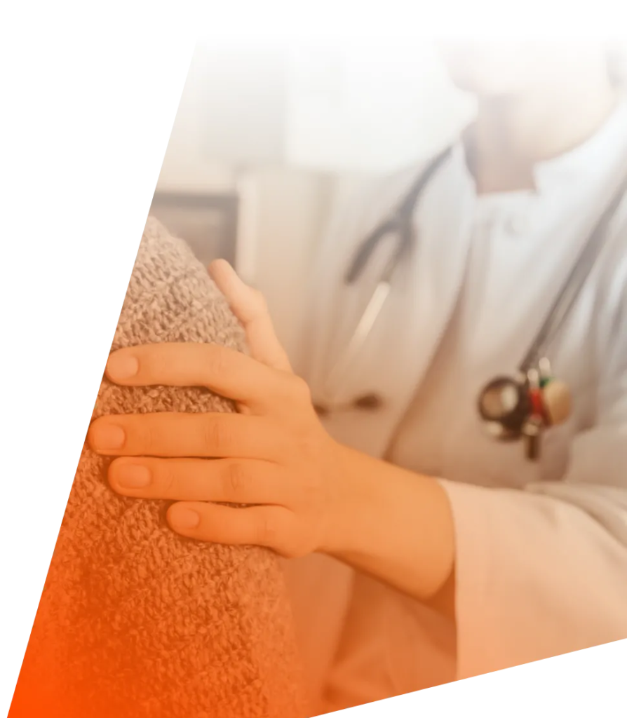 A doctor showing support by holding the patient's shoulder