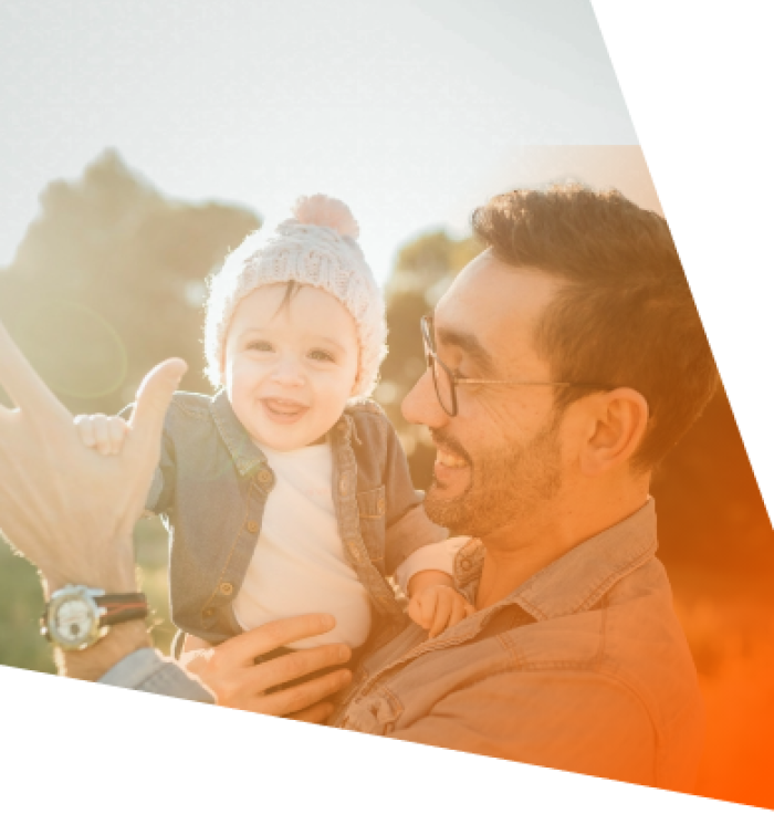 A man holding a smiling child in his arms